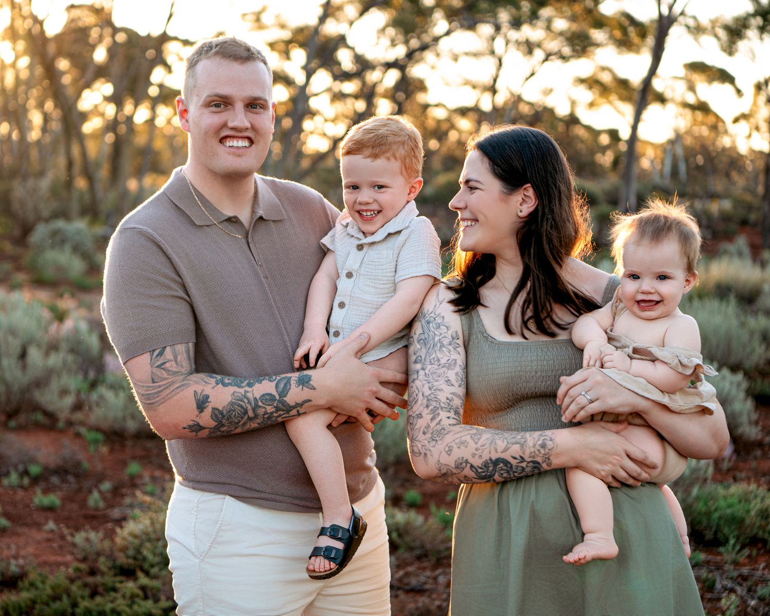 Children stroll along a rustic path at sunset during a golden hour outdoor family photo session.
