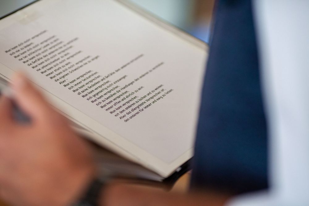 A blurred close-up view of an open book page with text visible against a blue background.