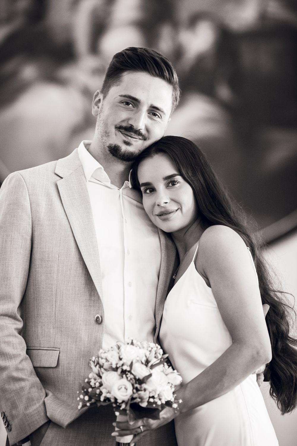 A romantic black and white wedding photo collage showing a couple in formal attire with a bridal bouquet.