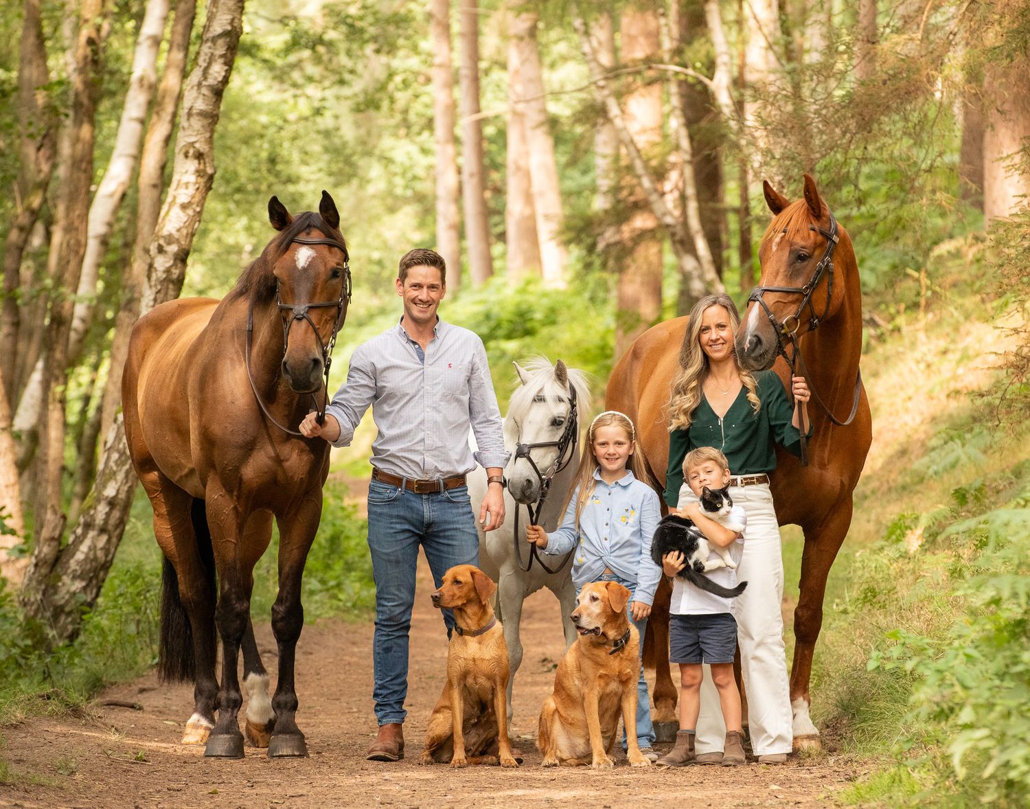 A horse and its rider enjoy an outdoor photoshoot session near rustic wooden fencing on a sunny day.