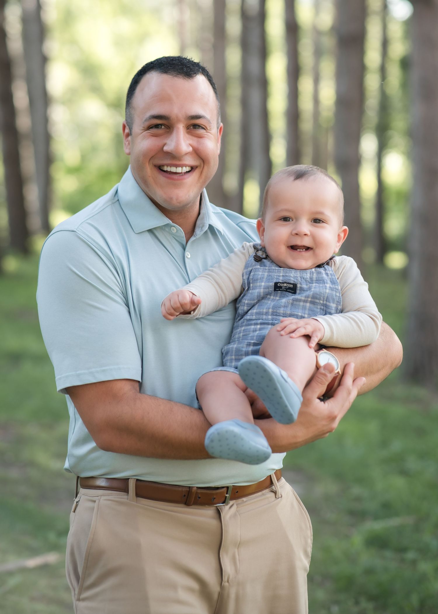 A joyful moment in a wooded forest setting with casual attire and natural lighting.