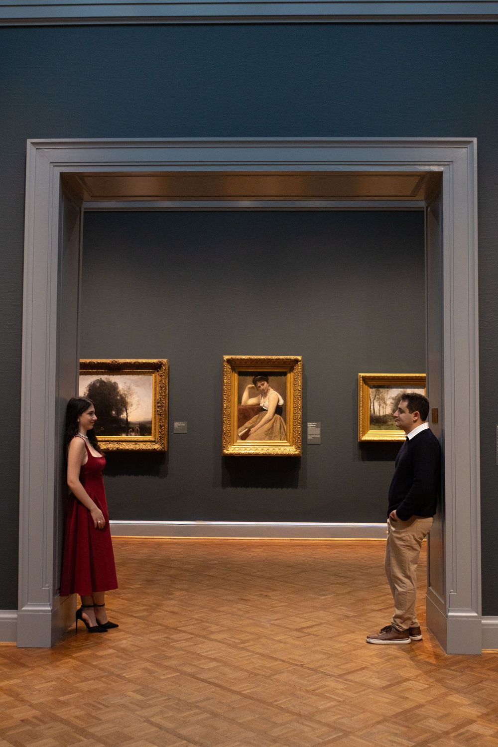 A sequence of photos showing a couple dancing in an art gallery with framed paintings on the walls.