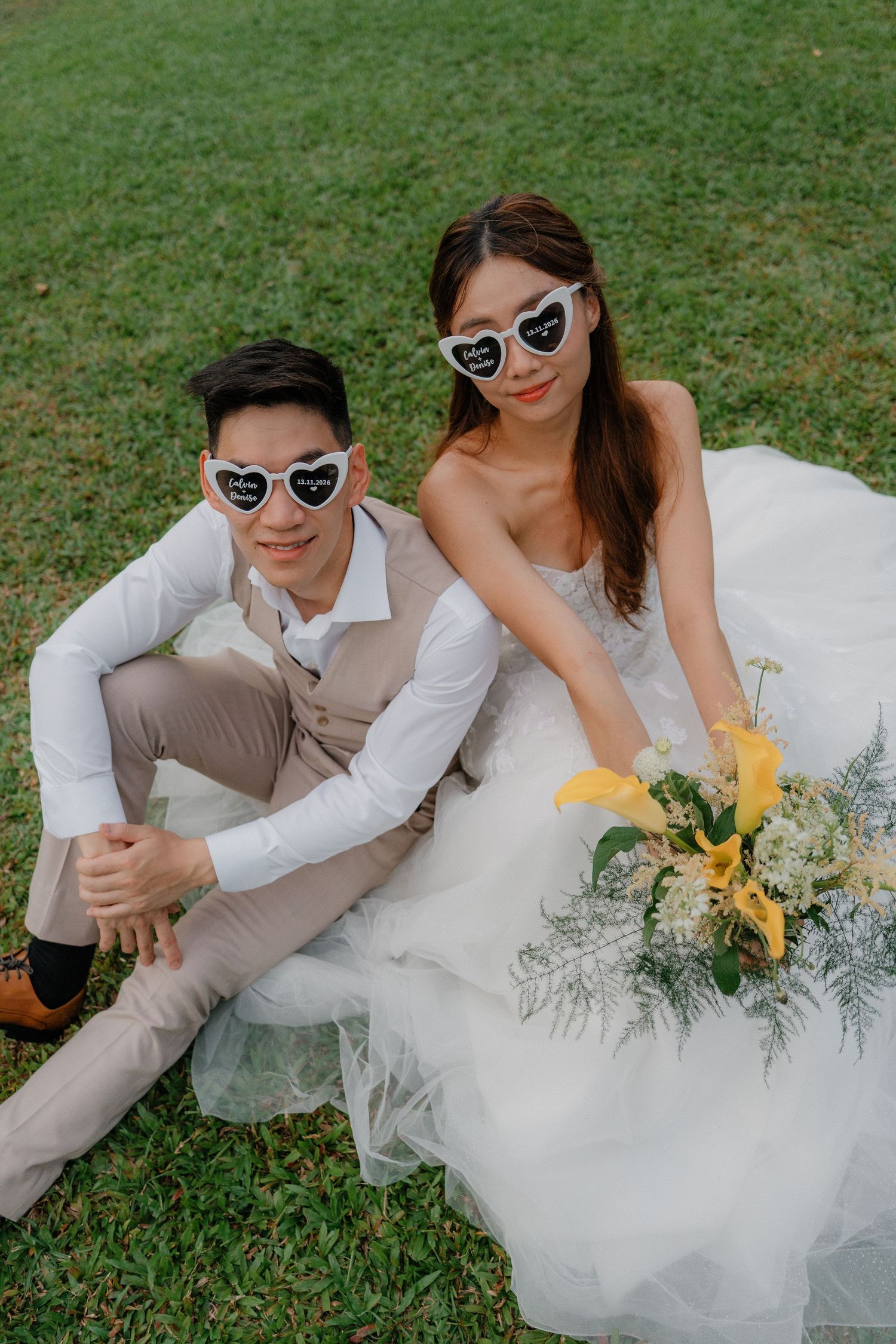 A romantic wedding photoshoot sequence showing a couple lying on grass in white and beige outfits with sunglasses.