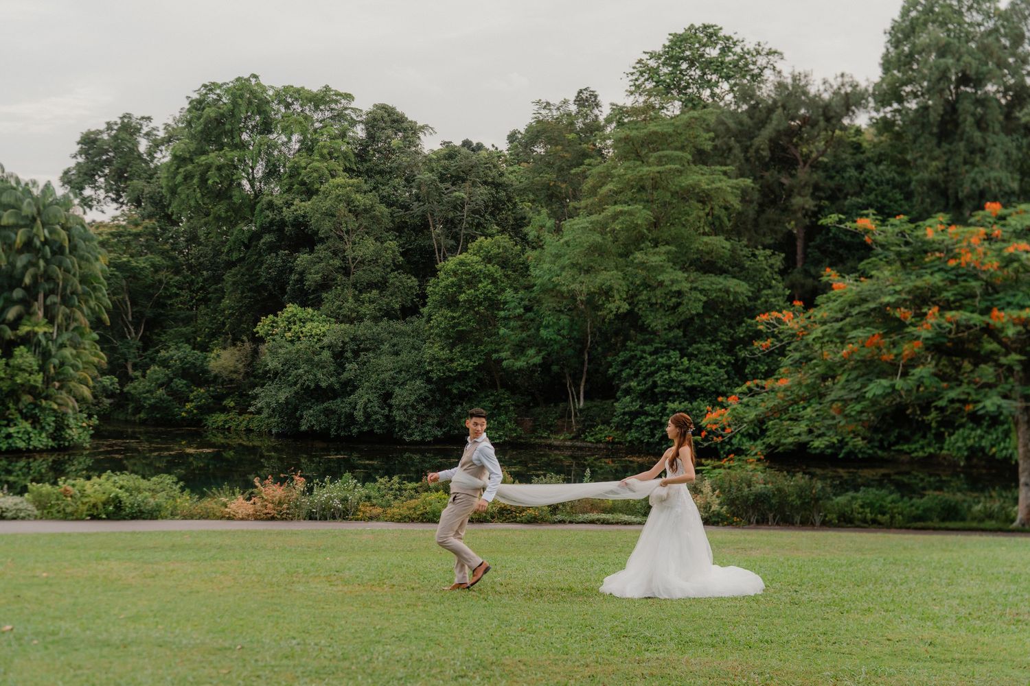 A creative wedding photoshoot sequence showing a distant couple in a lush green field with trees in the background.
