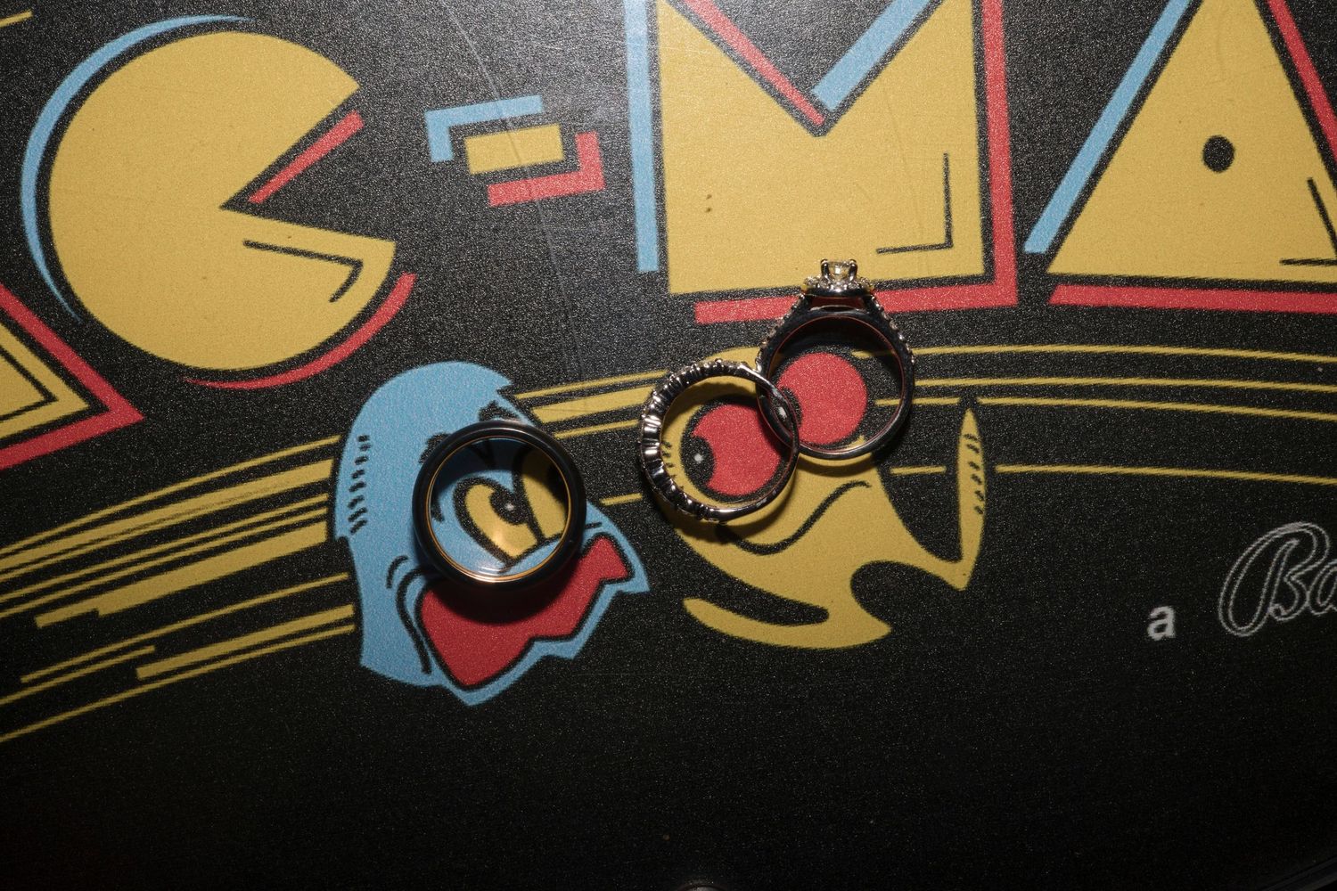 A close-up detail of a vintage Pac-Man arcade game artwork showing classic character graphics in bright colors.