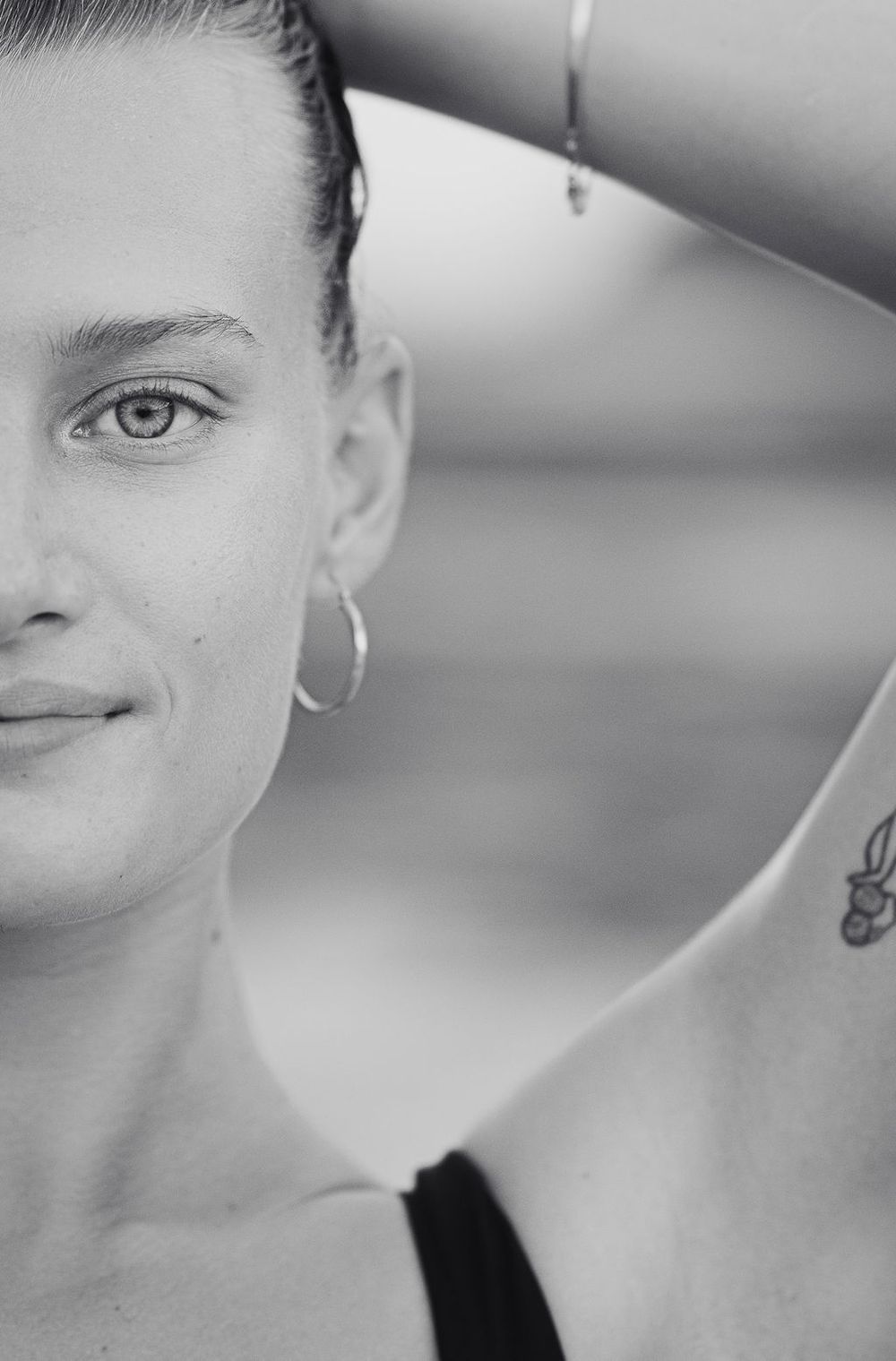 A series of close-up black and white profile portraits showing partial facial features and jewelry against a light background.