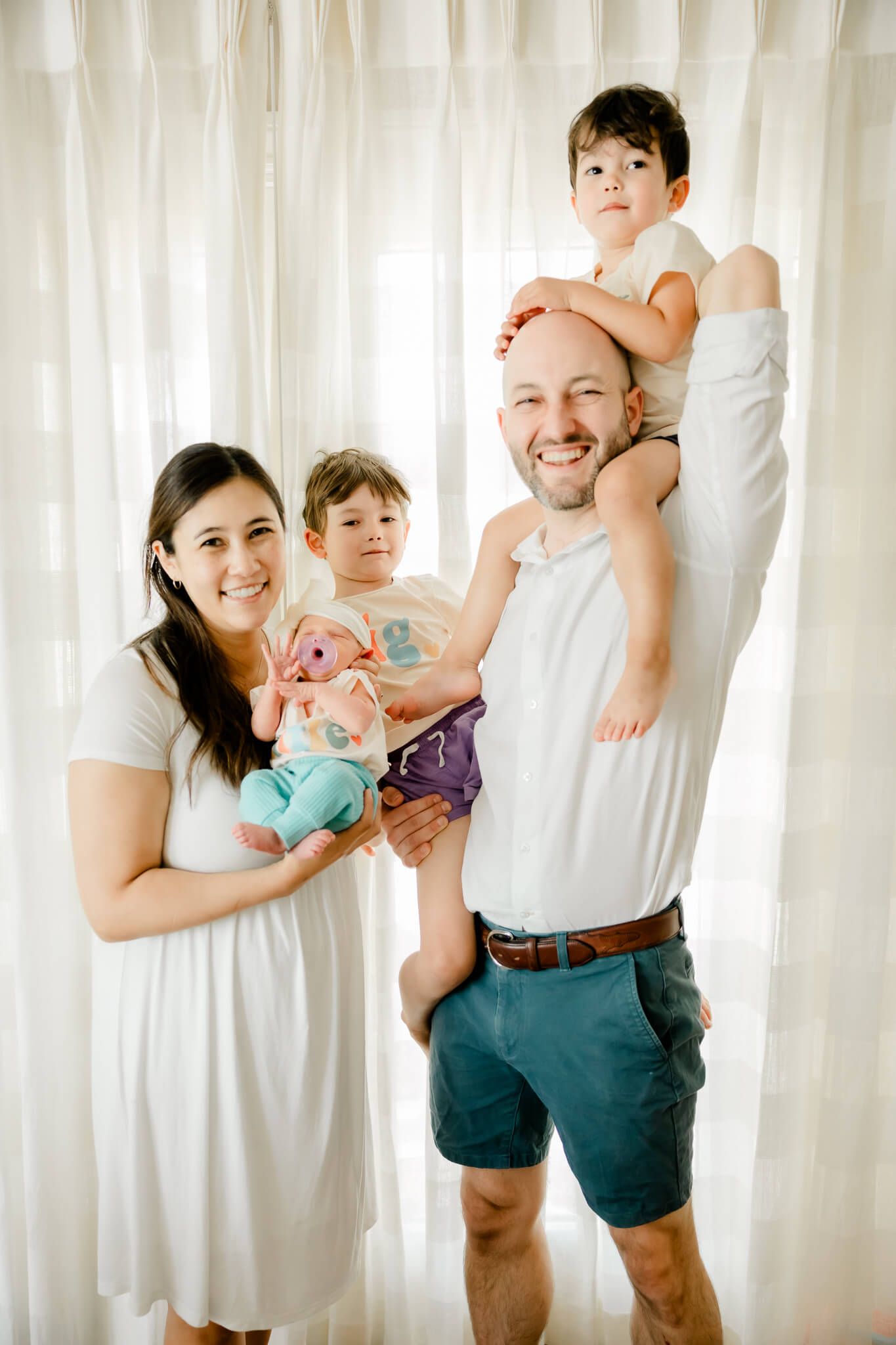 father and big brothers bonding with newborn baby girl Menlo Park