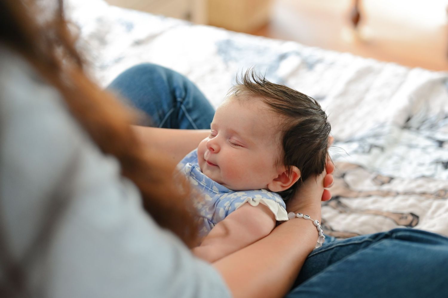 A series of outdoor photos showing tender moments between parent and child against a lush green park backdrop.