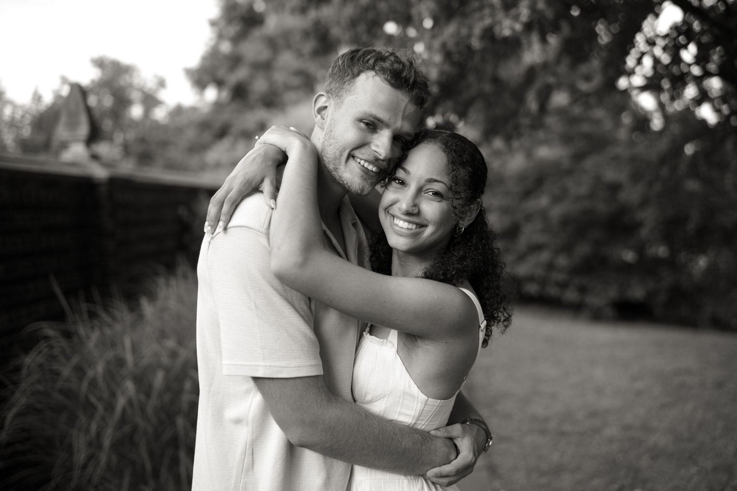 A collection of black and white romantic couple engagement photos showing intimate embraces outdoors.