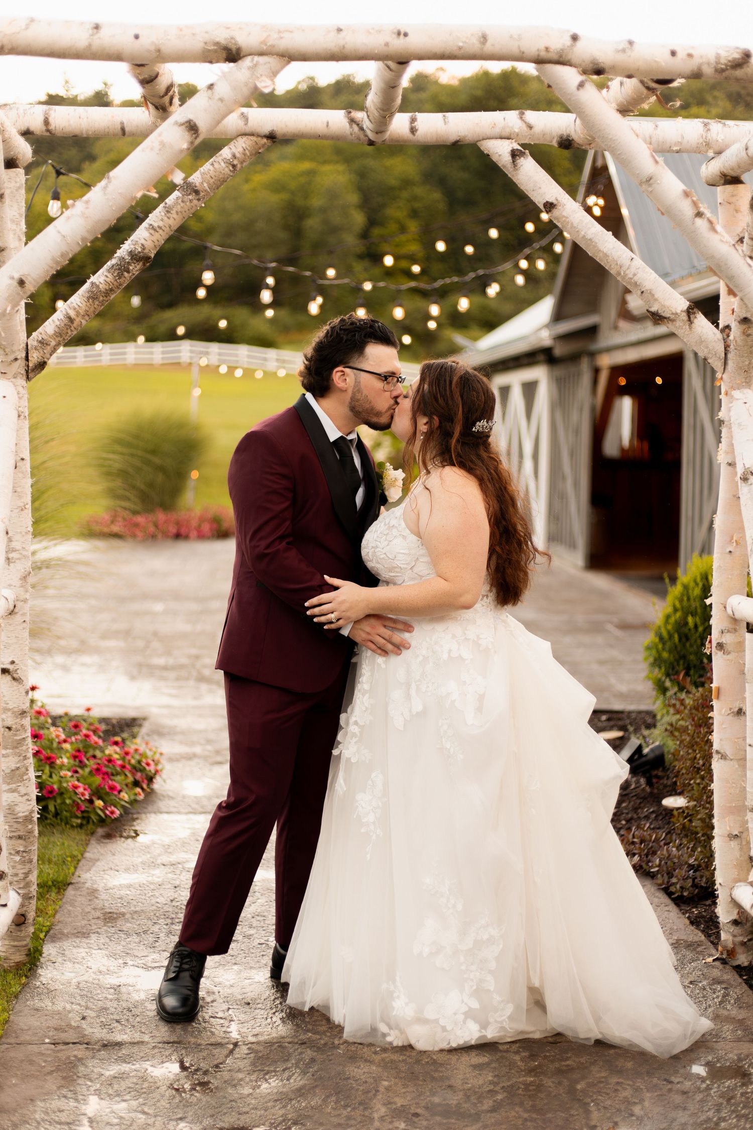 Romantic outdoor wedding venue decorated with string lights and white pergola during an intimate celebration.