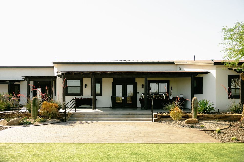 Contemporary white building with clean lines set against desert landscape.