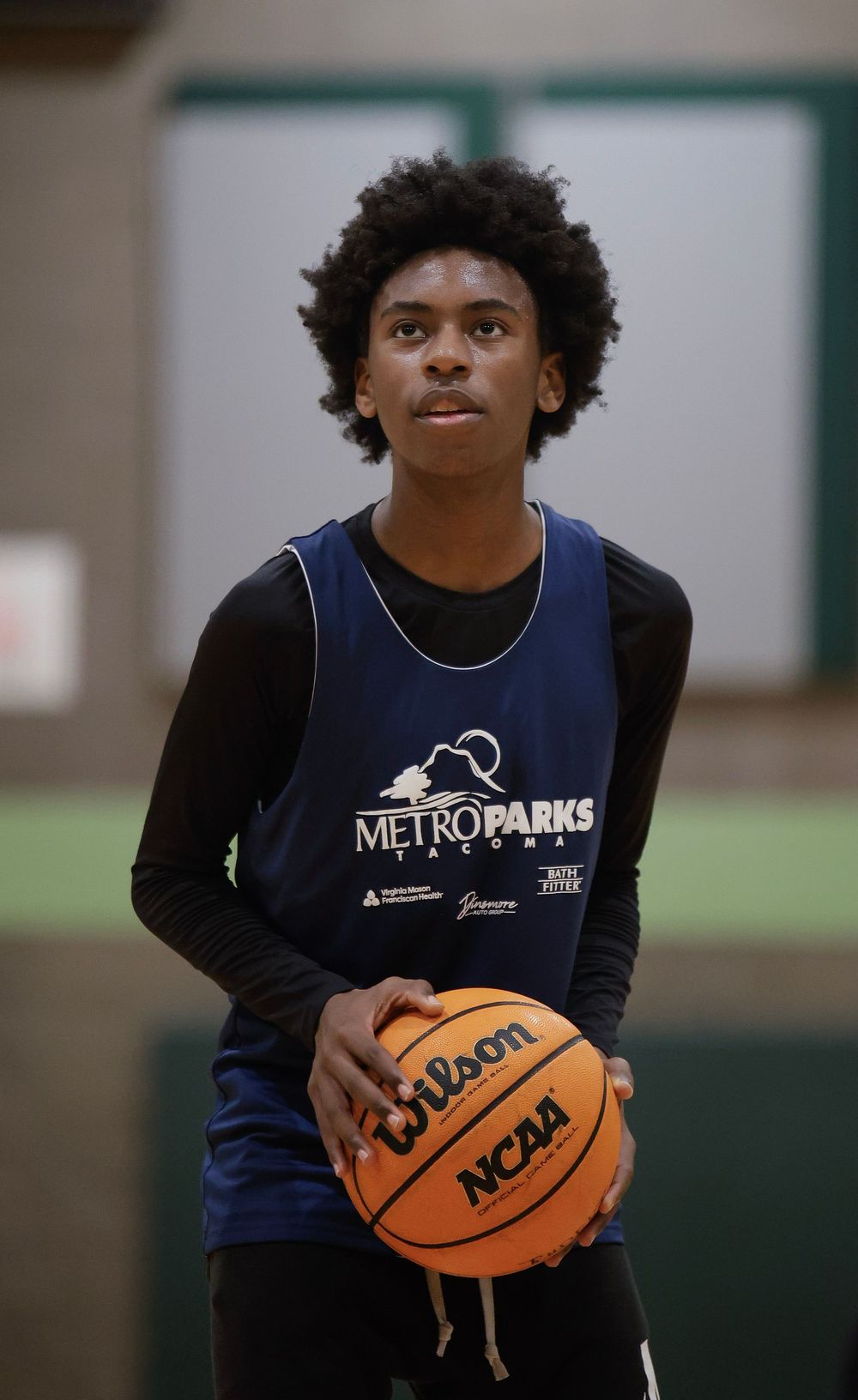 Action sports photography. Image of a young man playing basketball about to shoot a free throw