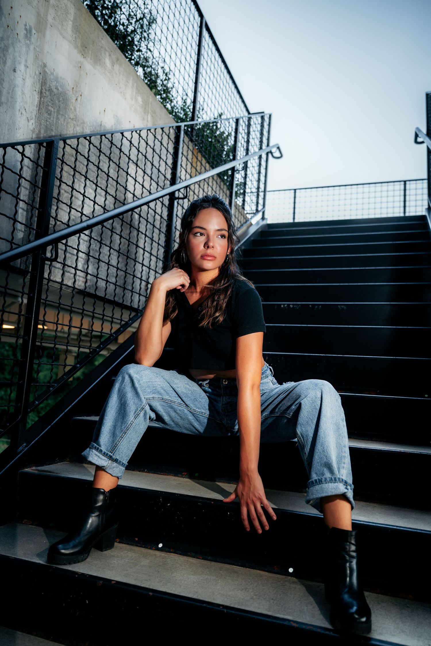 Artistic photo series showing a figure sitting on concrete stairs in moody lighting.