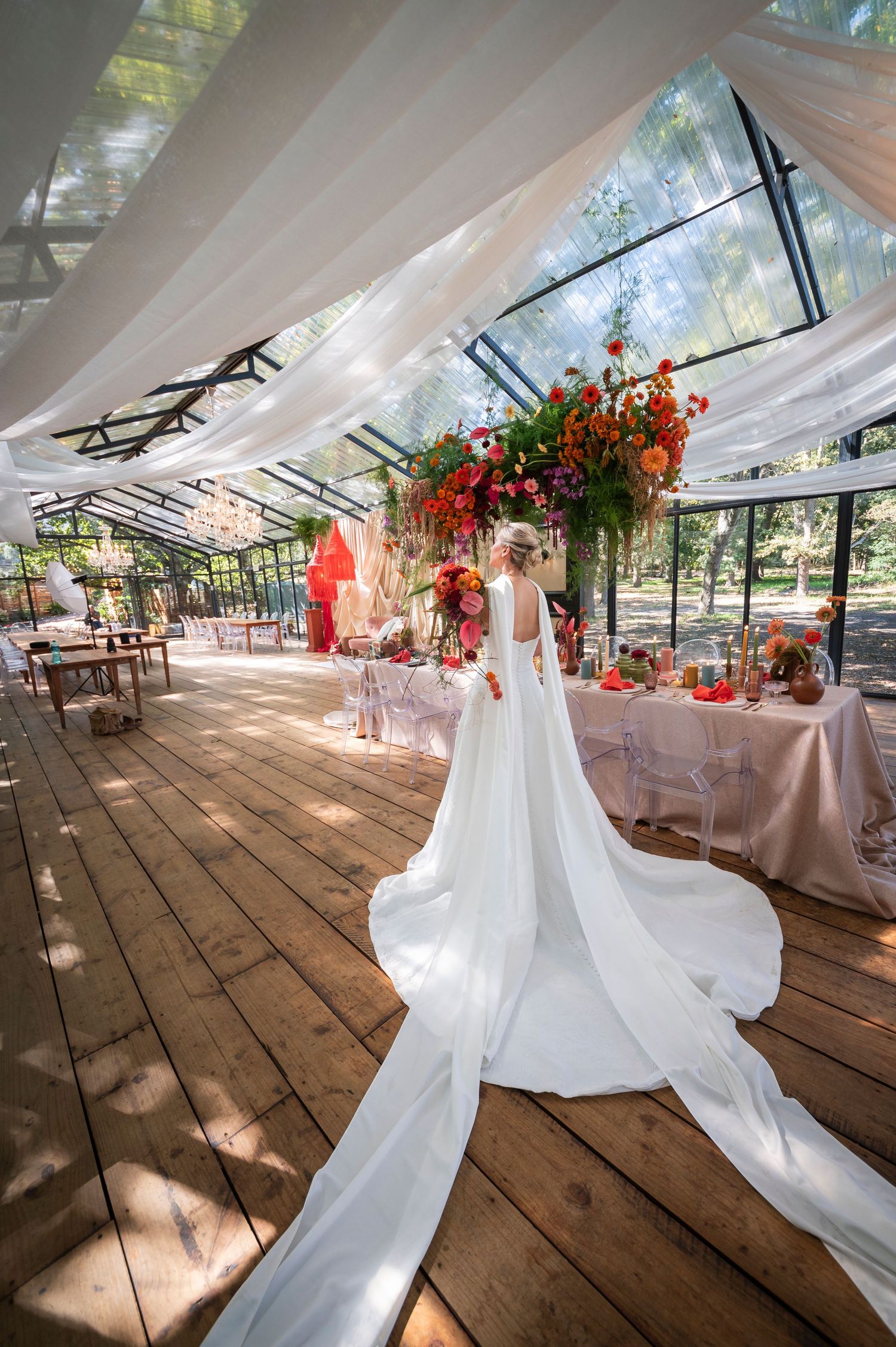 Close-up detail of white wedding dress with delicate embroidery and textured fabric in natural lighting.