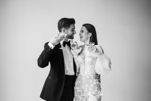 An elegant black and white portrait of a couple in formal wedding attire.