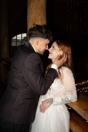 Intimate wedding photo series captured in a dimly lit indoor setting with romantic ambiance.