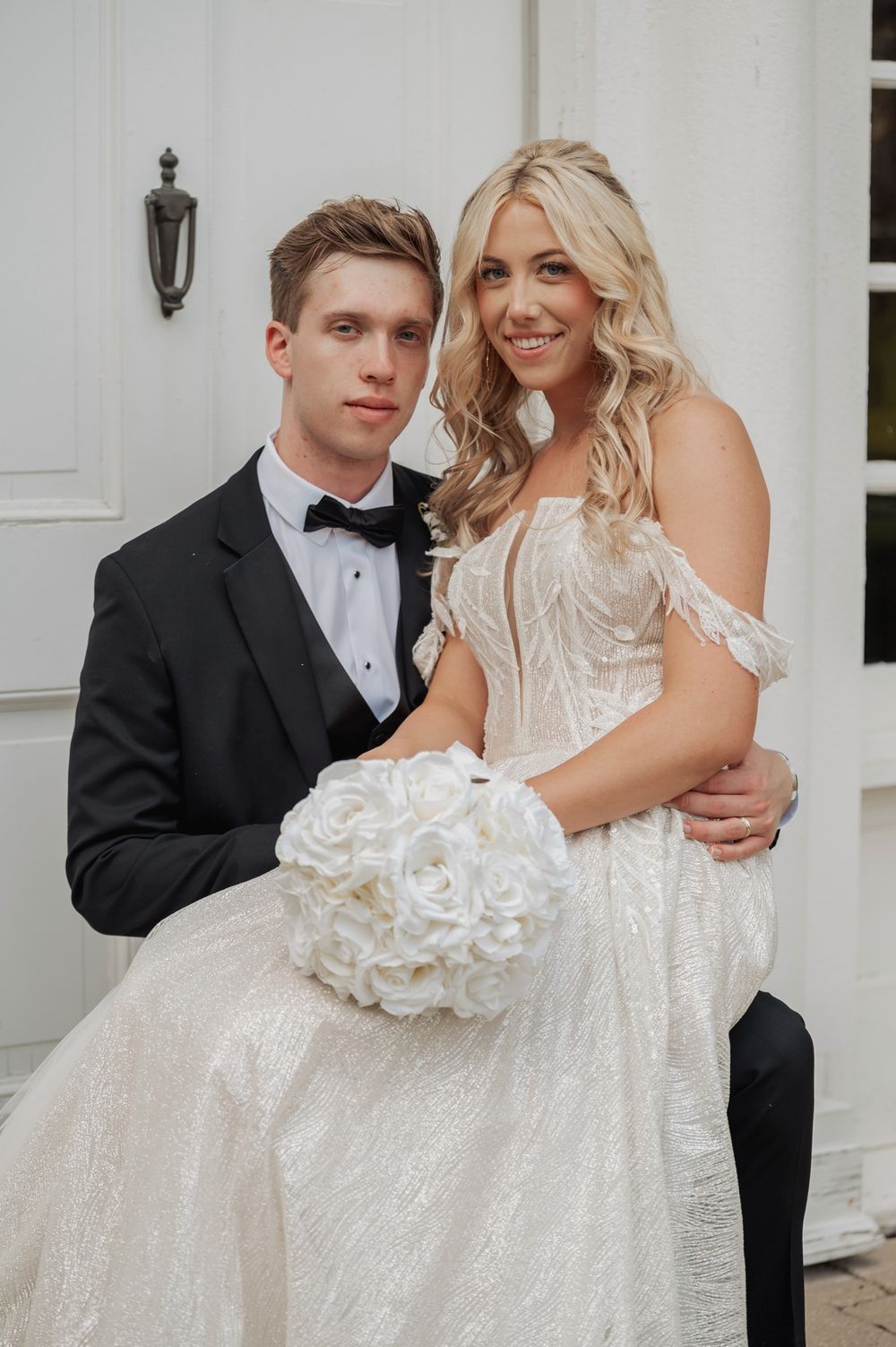 A couple in formal wedding attire poses together in front of a white building in a series of romantic shots.