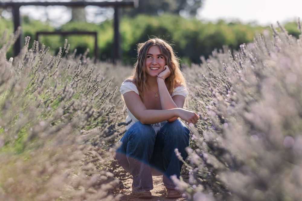 Casual outdoor portrait among blooming lavender flowers at golden hour.