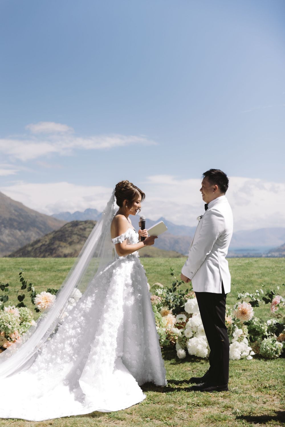 Bride and groom exchanging vows at outdoor mountain wedding