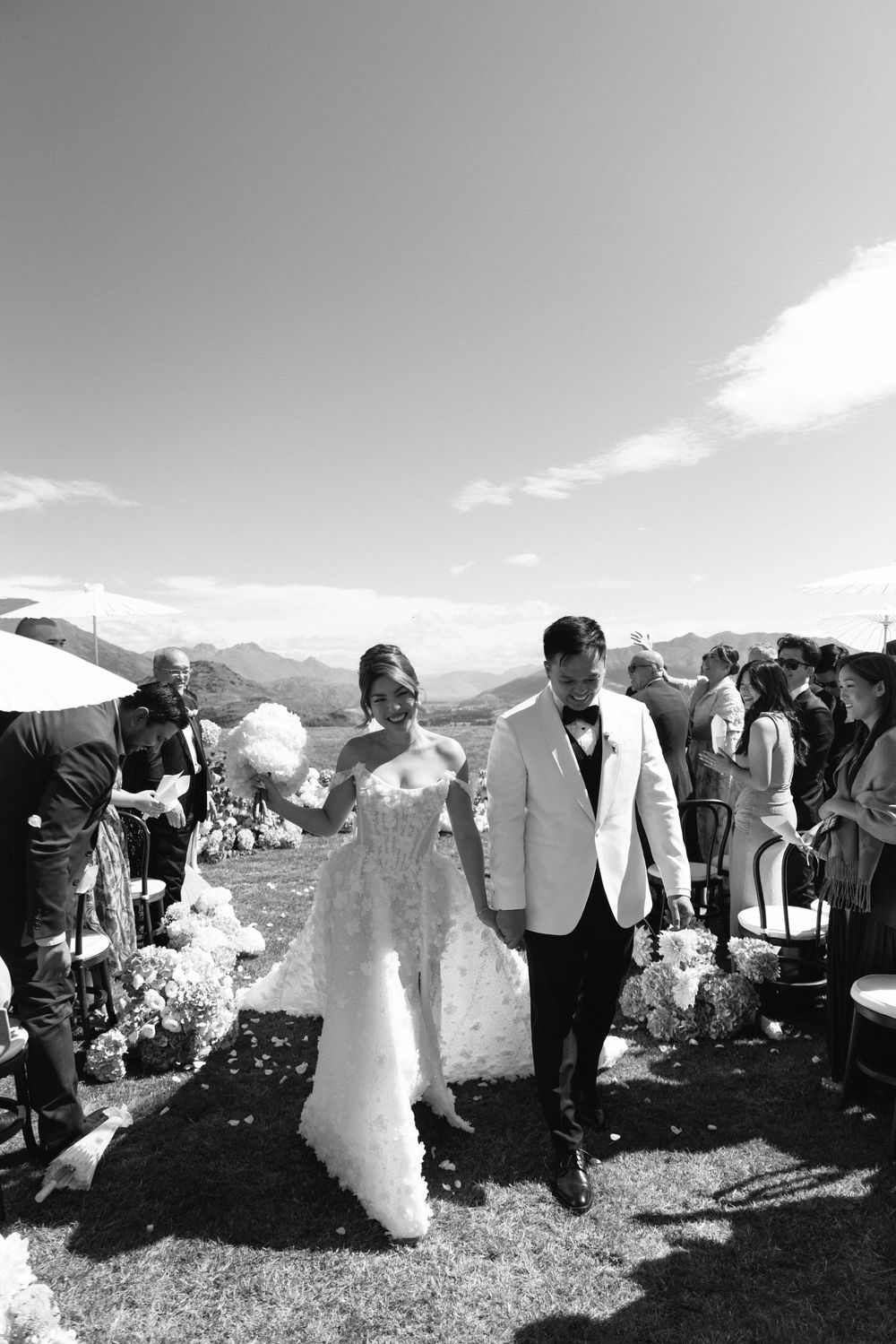 Bride and groom walking together after outdoor wedding ceremony