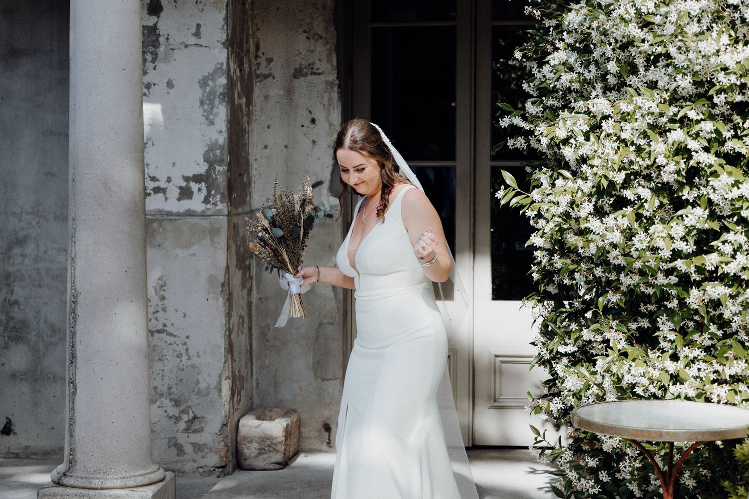 A bride in her wedding dress dancing down the aisle for her wedding ceremony, captured by Apertured Media Auckland Wedding Photographer.