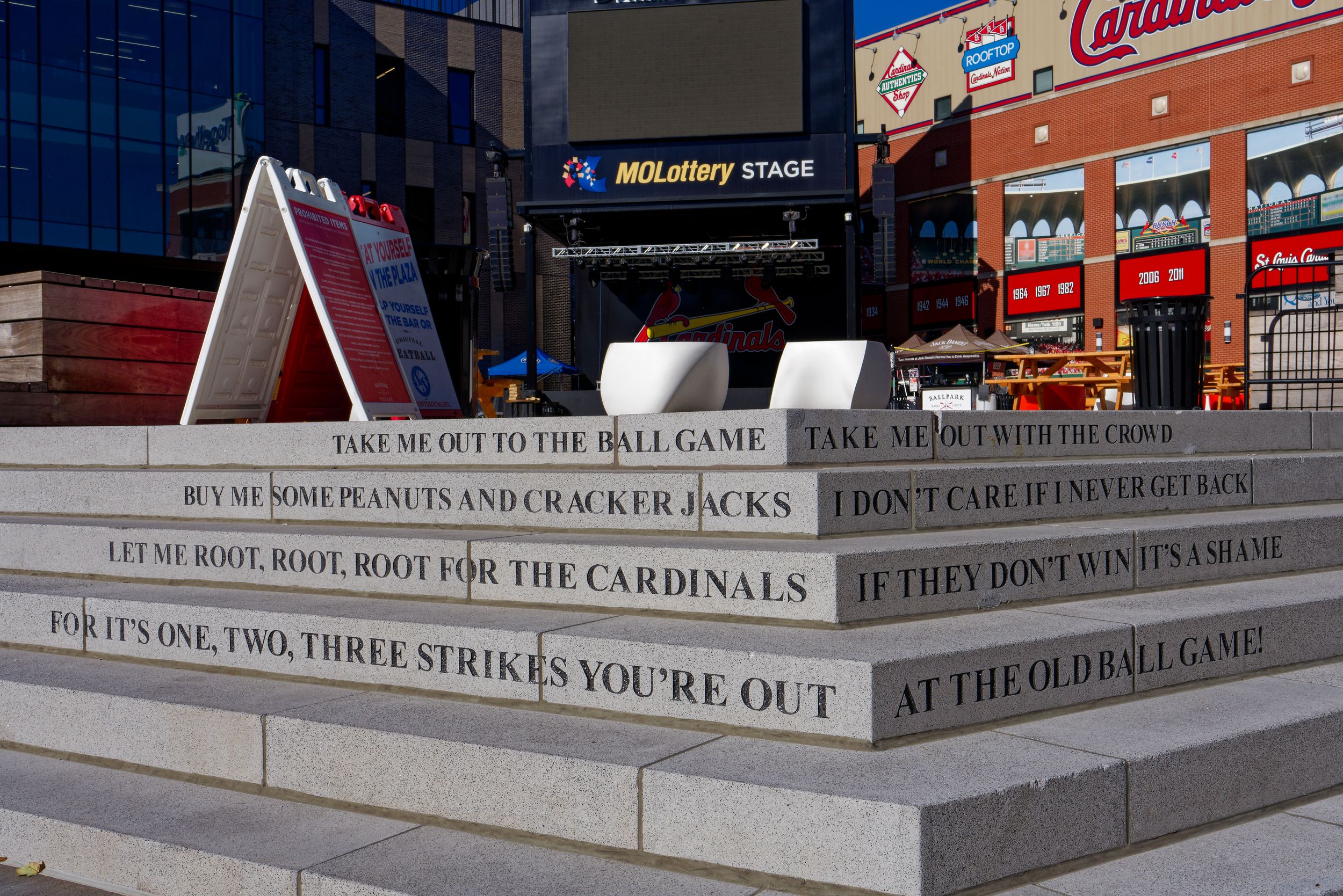 Inspirational baseball quotes engraved on stadium steps featuring Cardinals team messaging.
