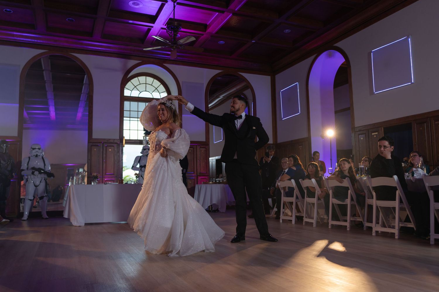Bride and groom share a magical first dance in an elegant wedding reception, surrounded by stormtroopers. A cinematic & unique wedding celeb
