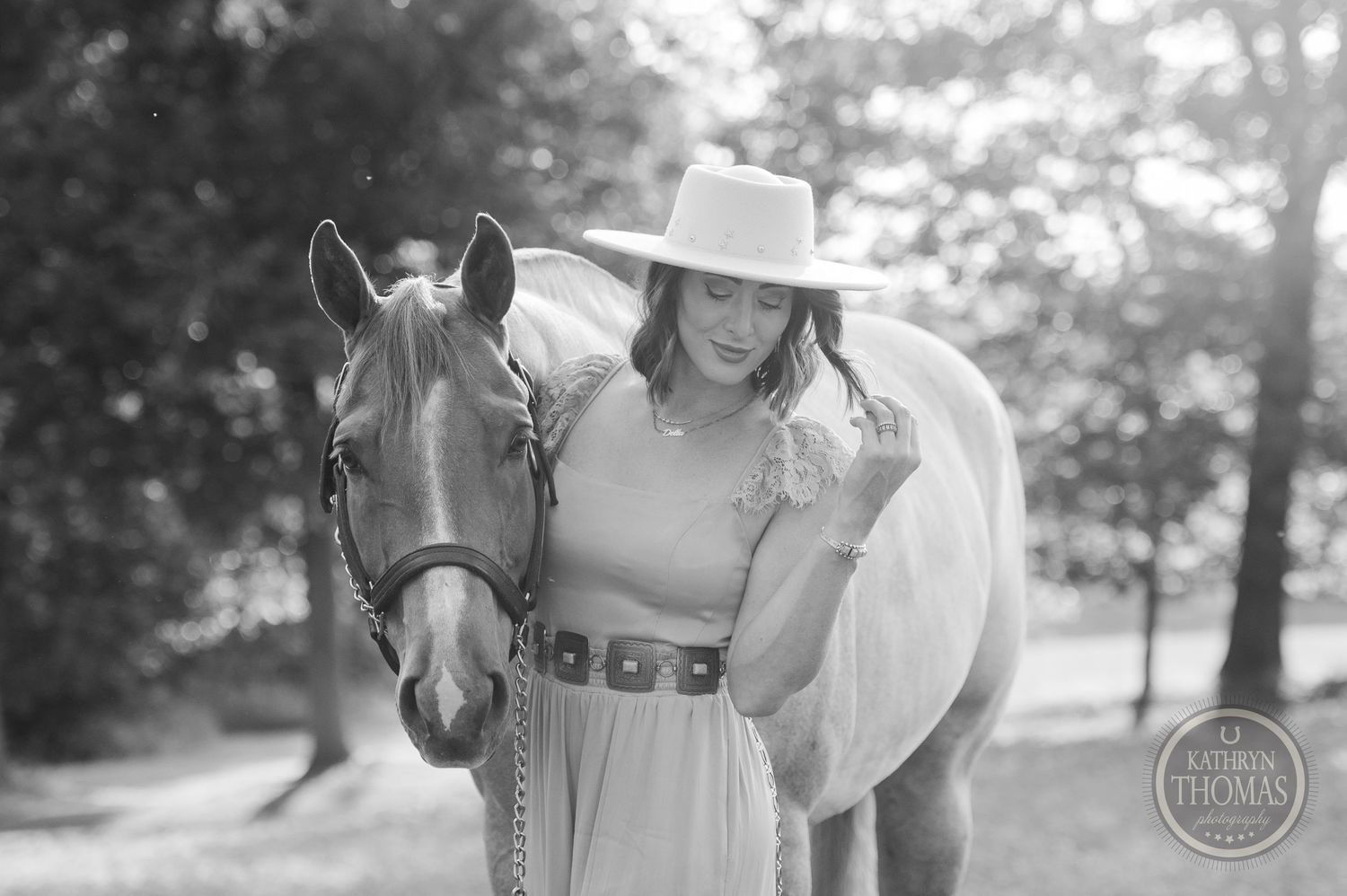Black and white portrait of a horse with companion in western attire.