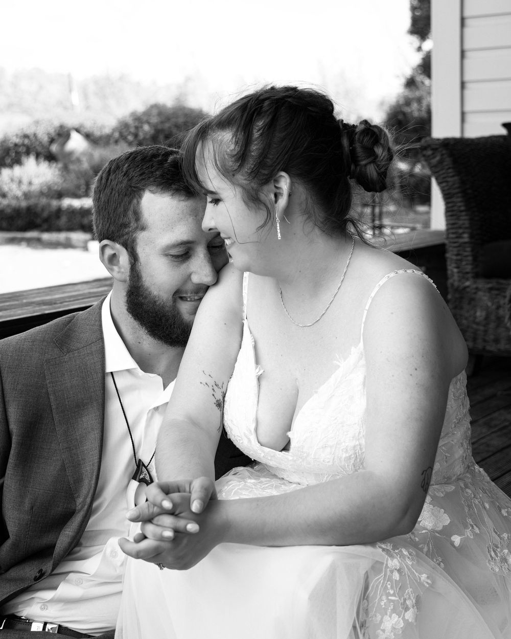 A black and white photo series shows a romantic couple sharing tender moments together outdoors.