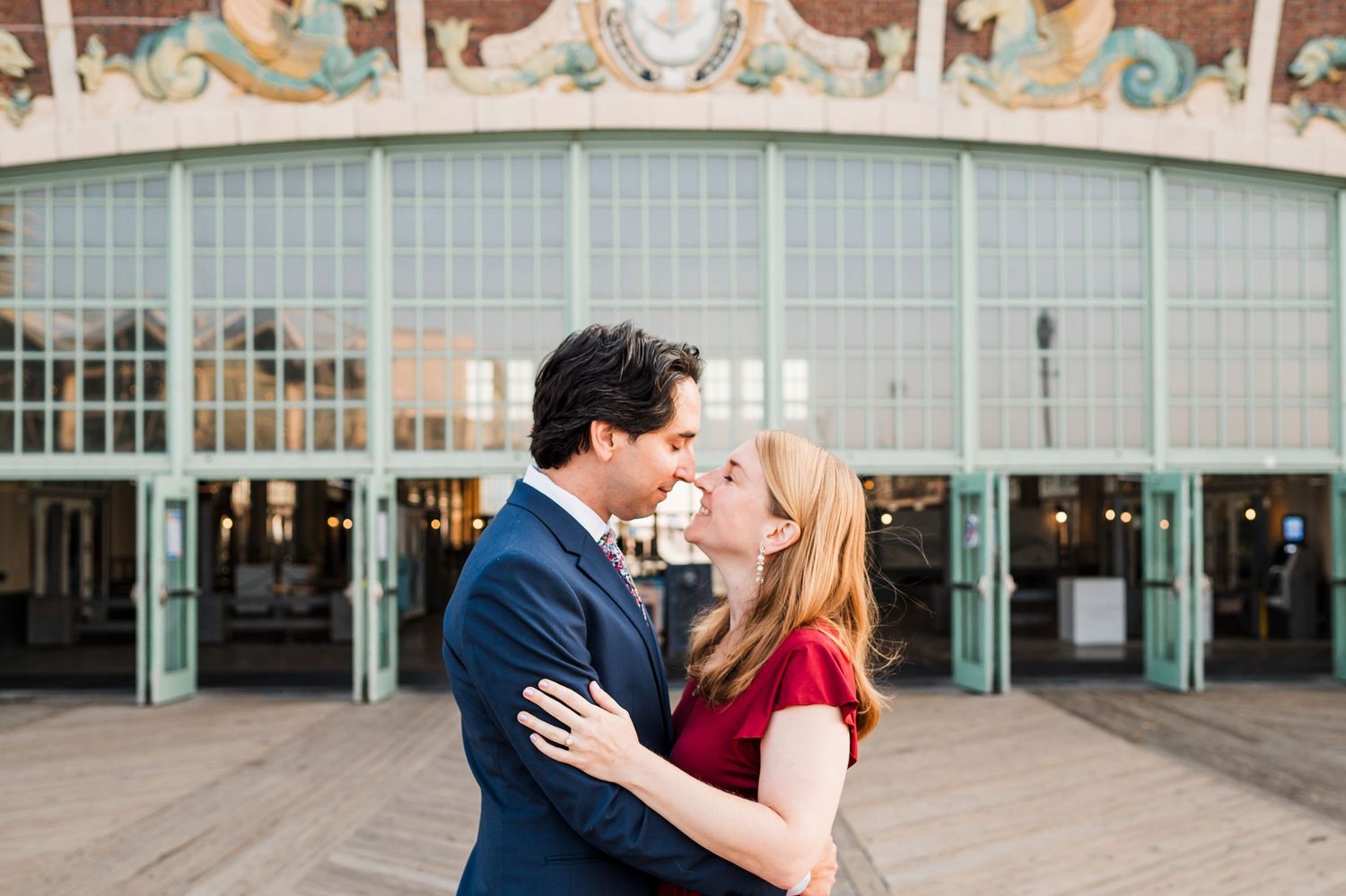 Romantic outdoor wedding photo with couple in formal attire standing in a grassy field.