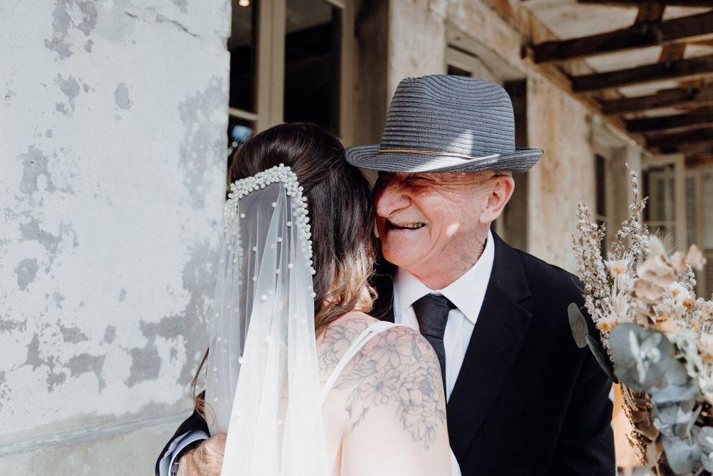 A joyful moment between the bride and her father, captured by Apertured Media Auckland Wedding Photographer.