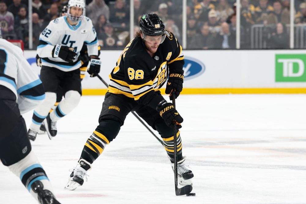 Hockey players from opposing teams compete for position during a professional NHL match.
