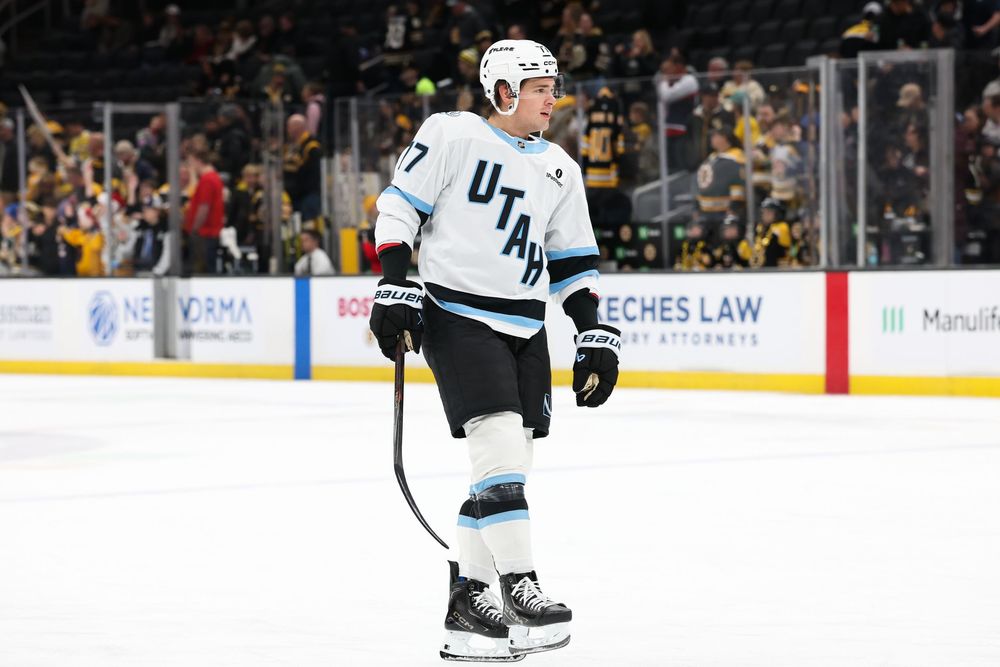 Hockey players from opposing teams battle for the puck during an intense NHL game.