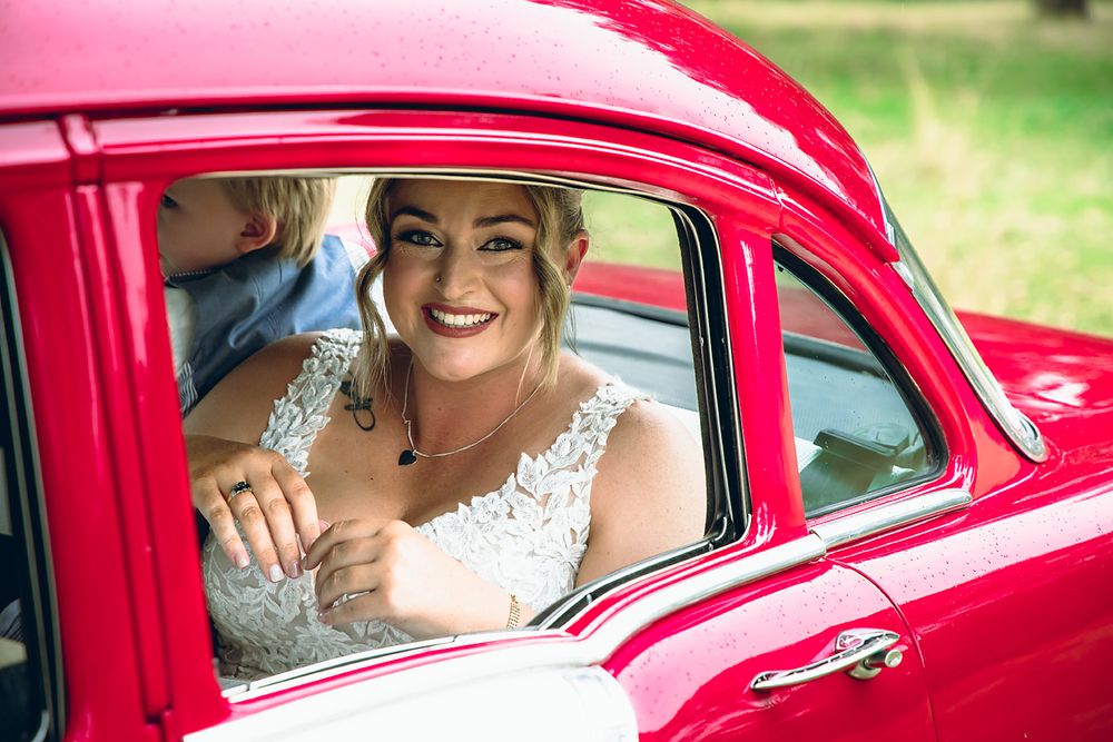 A series of wedding photos showing a bride in a classic red vintage car.