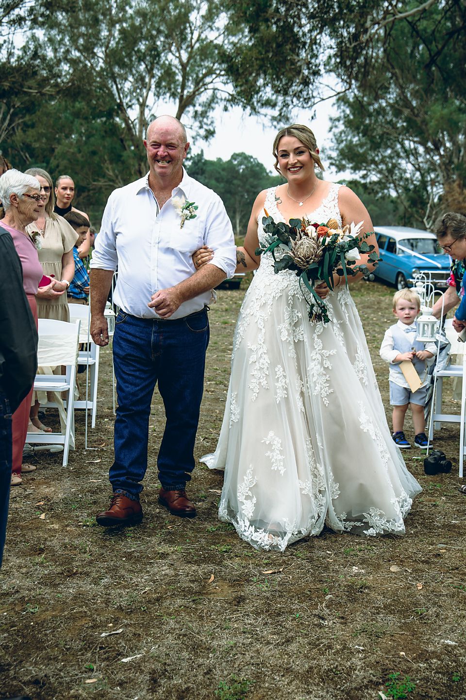 A series of candid moments at an outdoor wedding showing guests and flowing white dresses on a grassy hillside.