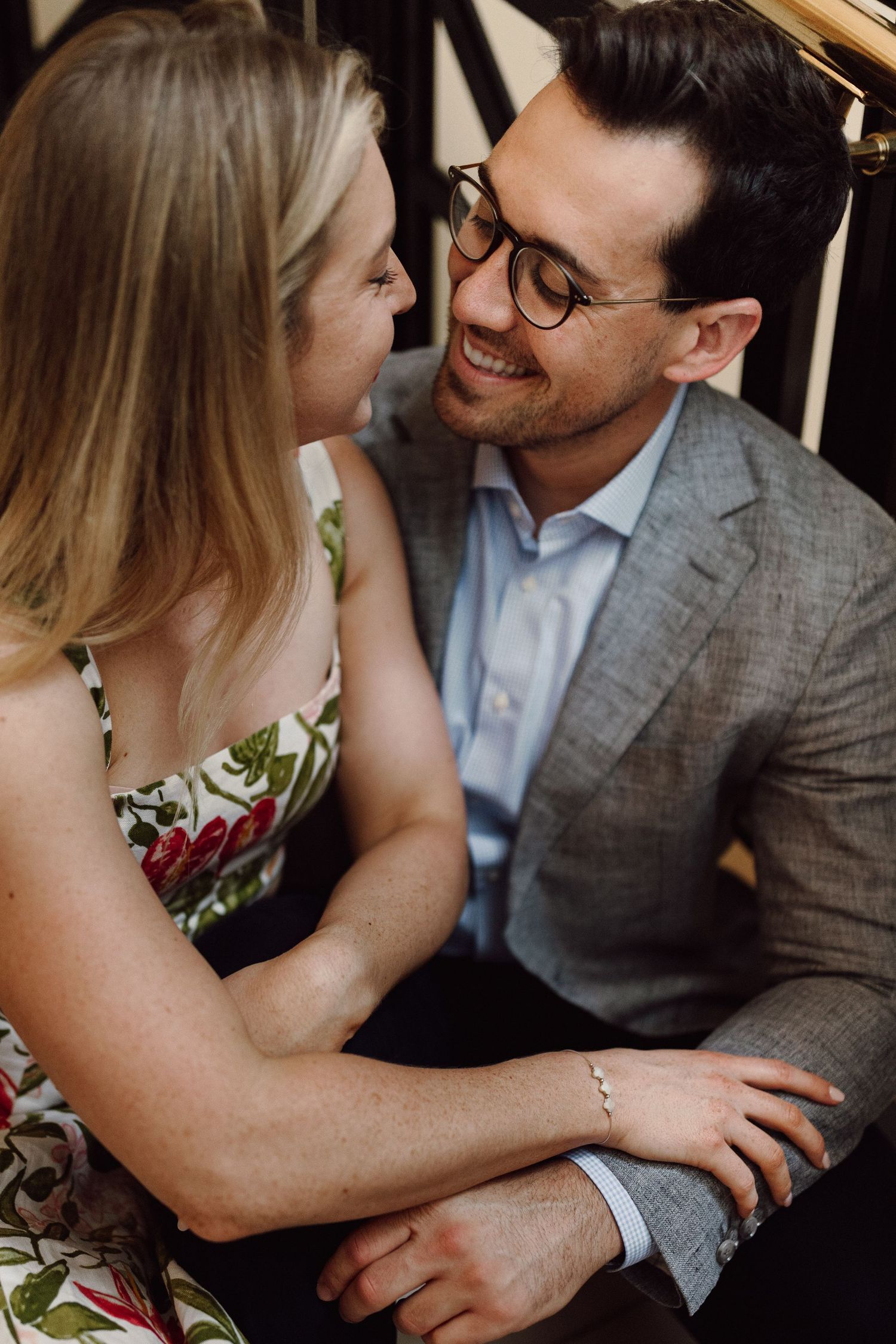 Romantic couple sharing an intimate moment while sitting together in a casual indoor setting.