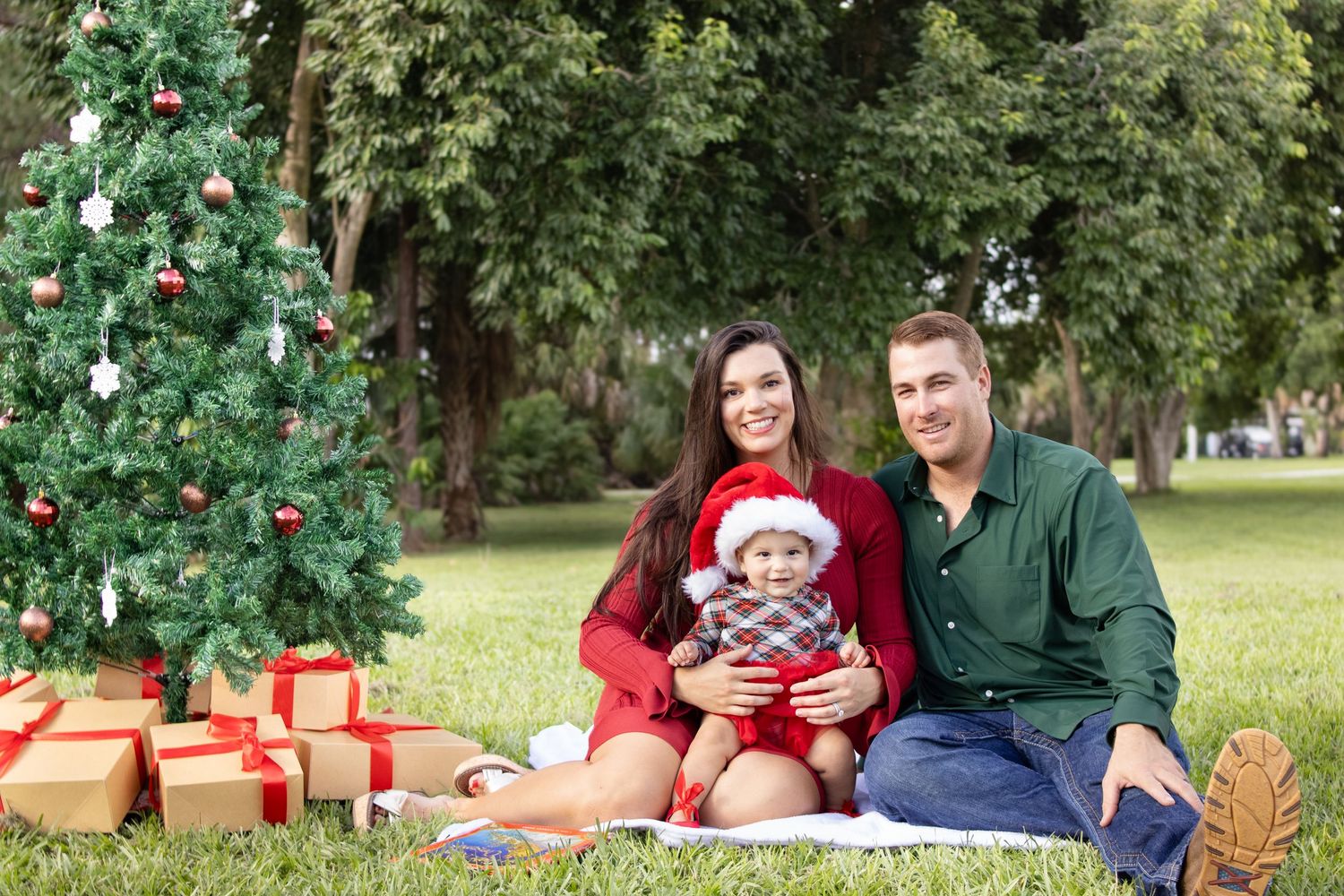Family smiling at outdoor Christmas ophotoshoot