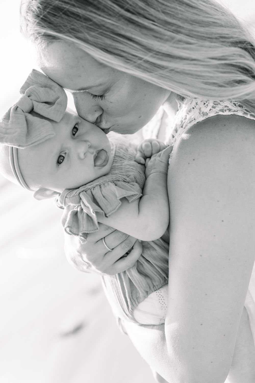 Black and white artistic portrait series showing close-up intimate moments in soft lighting.