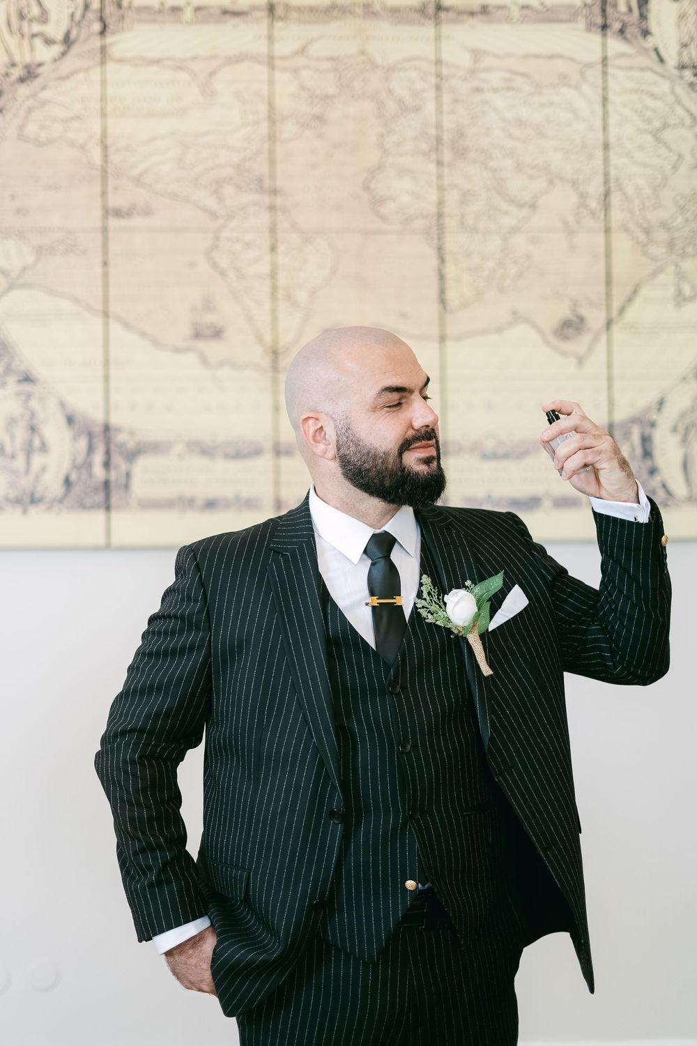 A sequence of four photos showing a person in a pinstripe suit making playful poses against a light background.