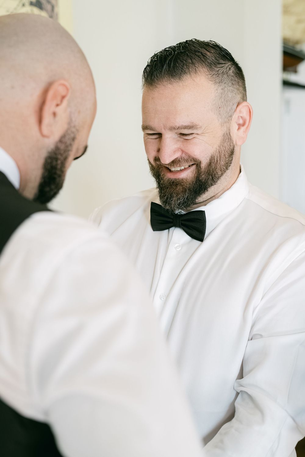 A series of candid shots showing someone in a white chef's coat smiling and looking down while working in a kitchen.