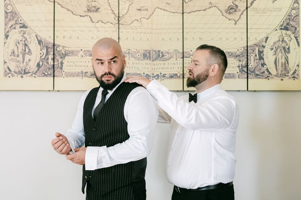 Two people in formal attire demonstrate self-defense moves in a sequence of training photos against a white wall.