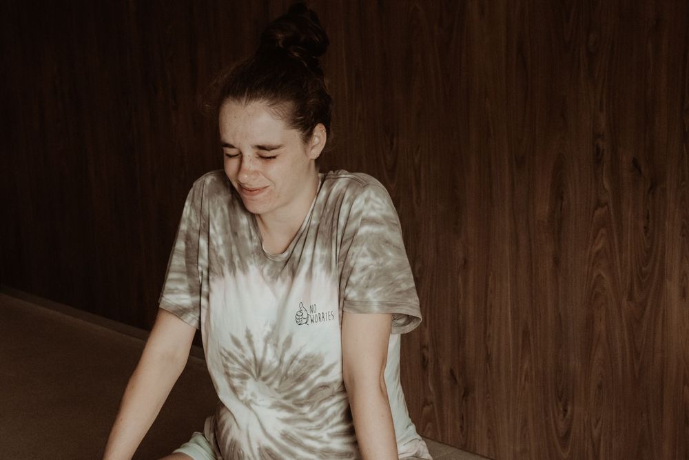 Pregnant woman sitting down preparing for labour and contractions during a central coast birth session.