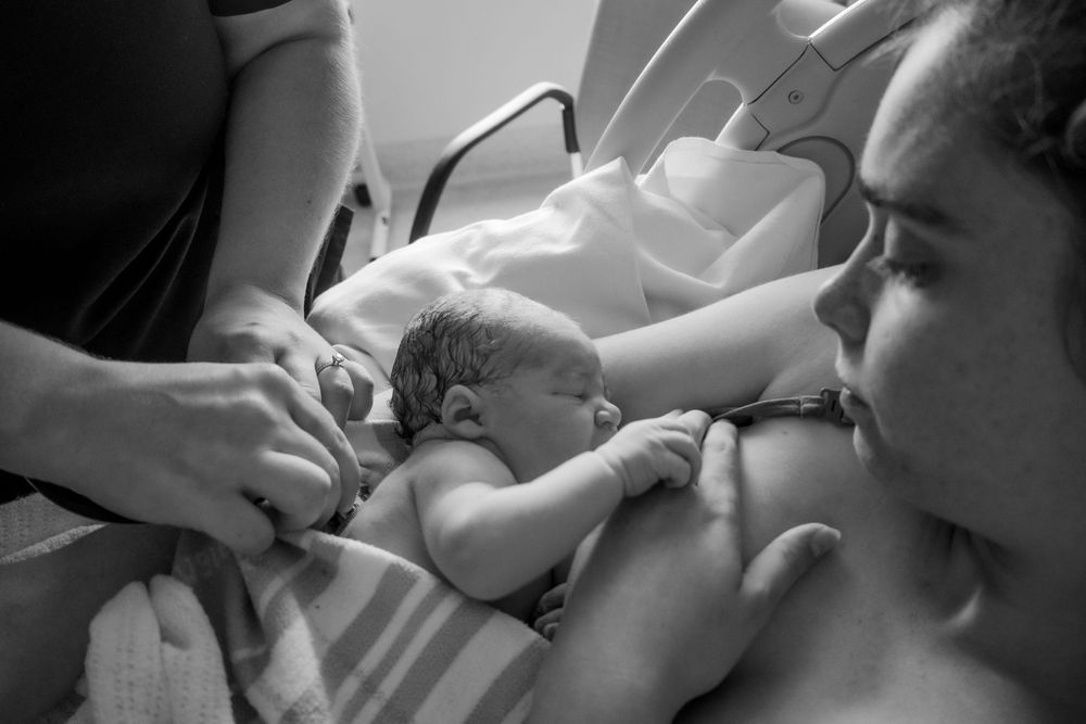 Intimate moment captured in black and white showing care and support during a central coast birth session.