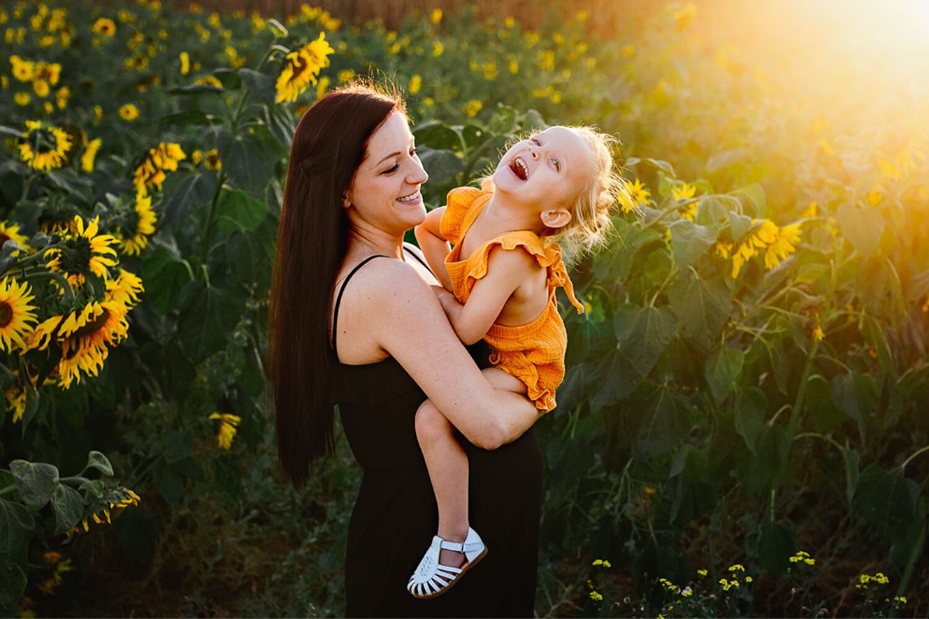 Maternity photoshoot with mother and daughter in a sunflower field
