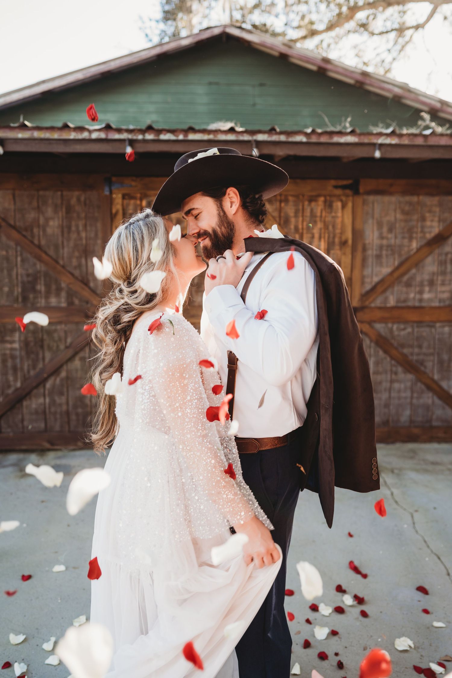 Bride and groom surrounded by rose petals during golden afternoon wedding portraits in Wesley Chapel Florida