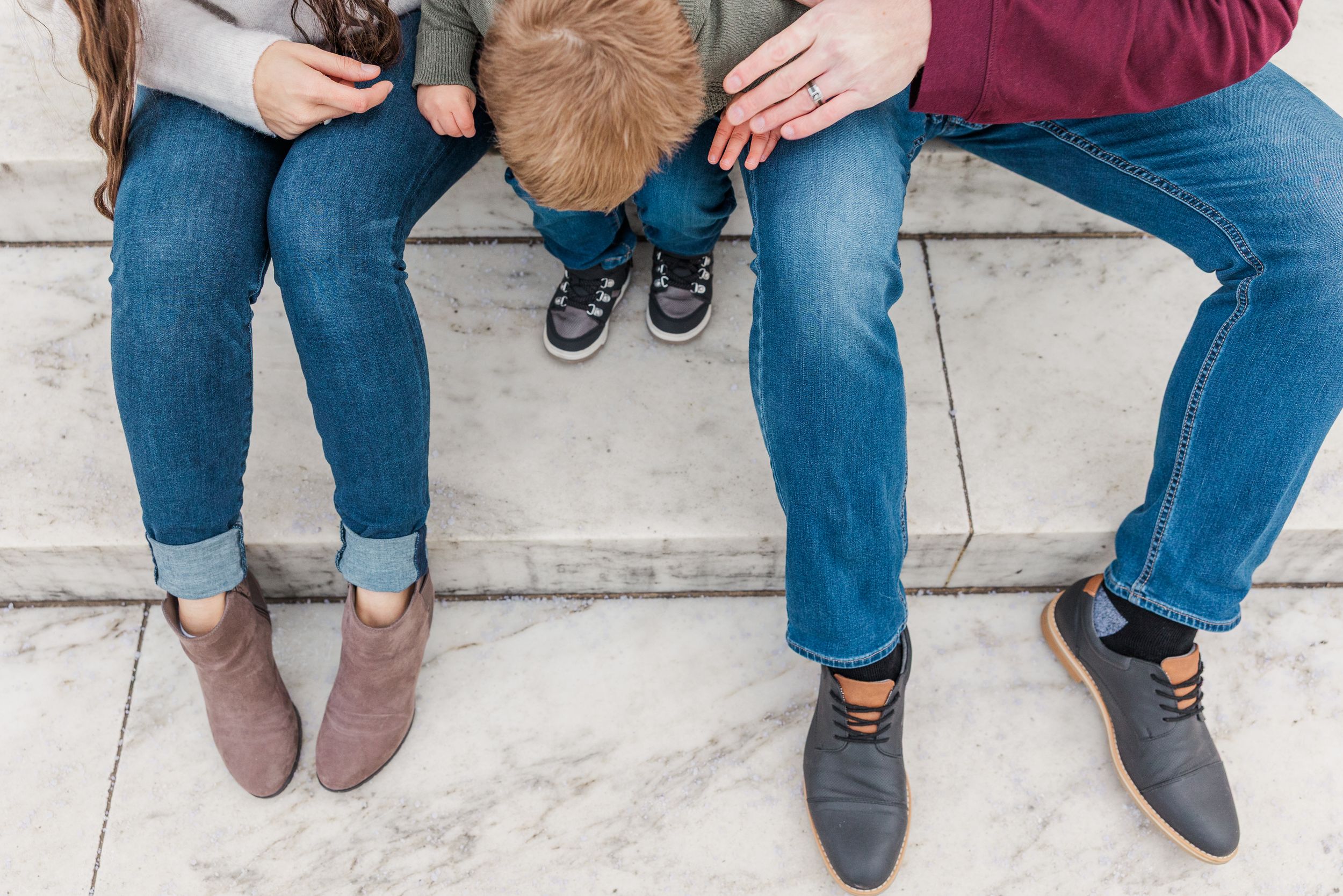 Detail shots of family members' feet and legs during outdoor photoshoot.