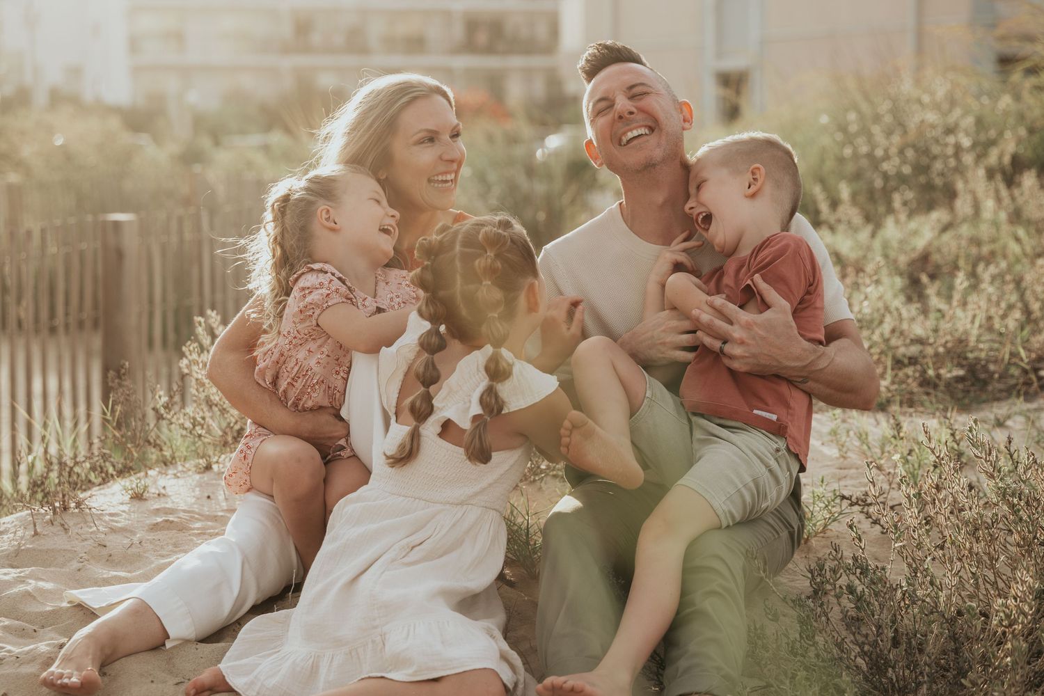 A series of candid family photos showing tender moments between parents and children in a sunlit outdoor setting.