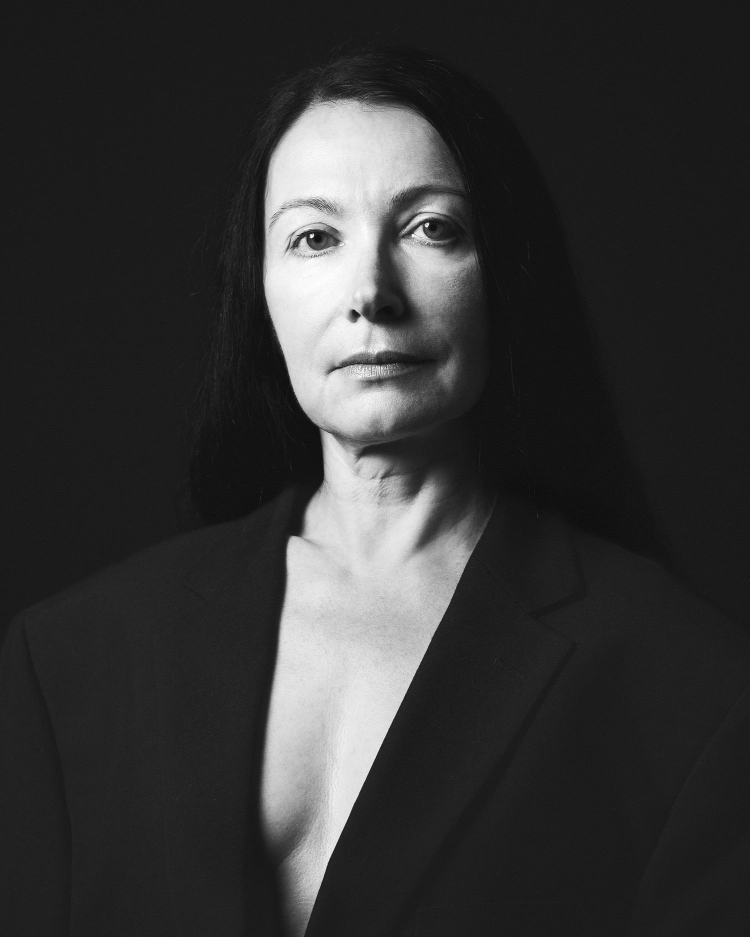 Black and white studio portrait of an elegant woman in a black blazer photographed in Norfolk