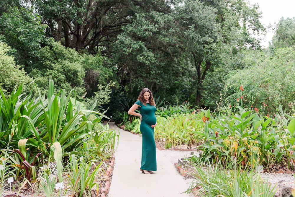 A series of photos showing someone in a green dress walking through a lush garden path surrounded by tall plants and flowers.