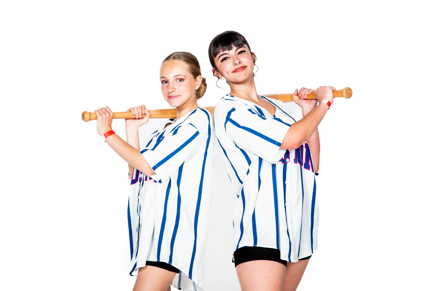 Baseball players in pinstripe uniforms demonstrate batting stance and grip positions for training purposes.